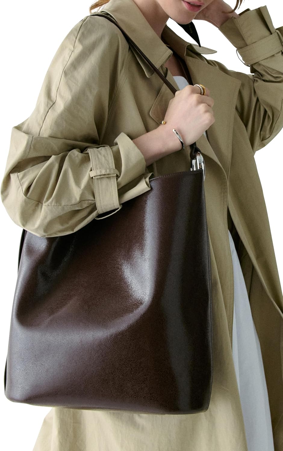 Fine grain leather bucket bag in neutral, shown from front view with handles — view 5