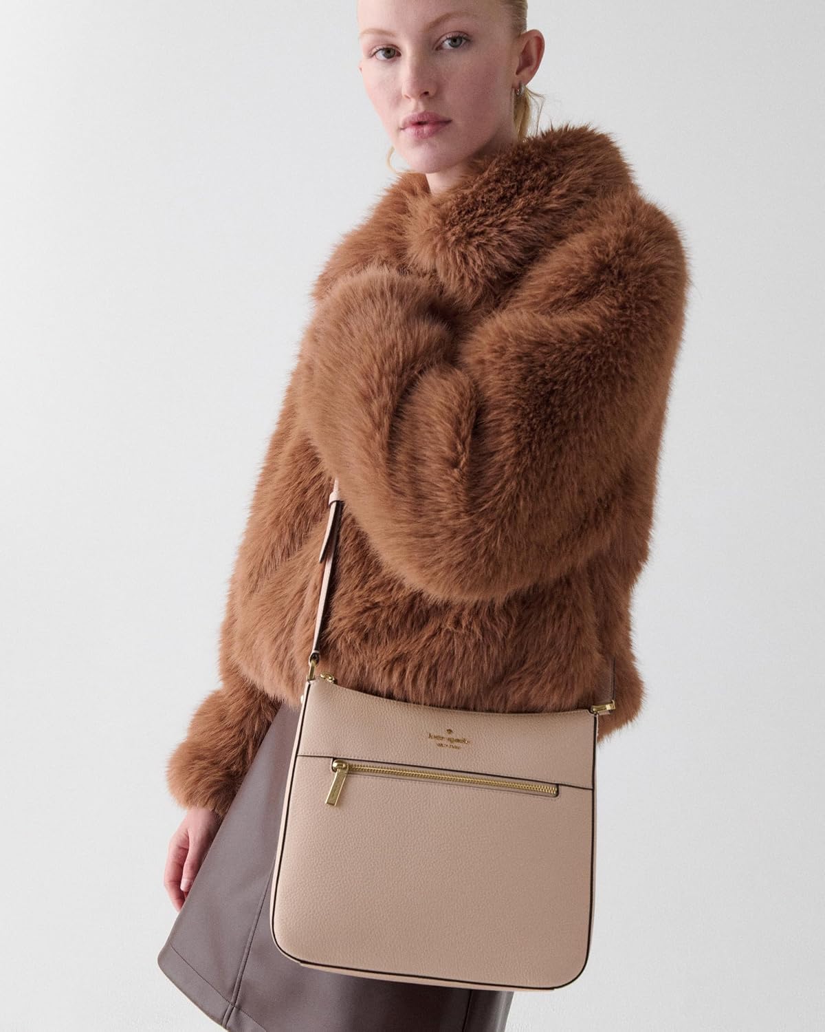 Pebbled leather saddle crossbody bag in neutral tone, front view — side