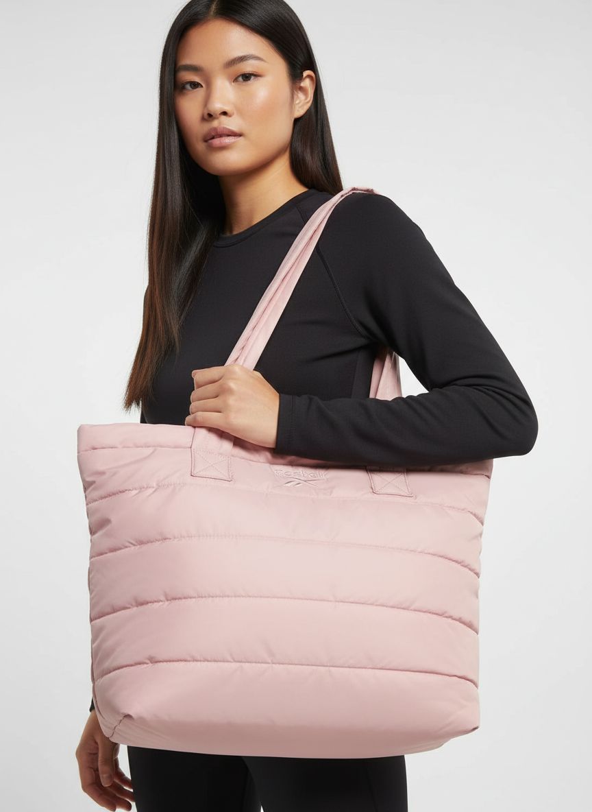 Quilted nylon puffer tote bag in neutral color, shown as work and travel carry-on — view 3b